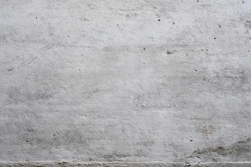 Close-up of a weathered concrete wall surface showing texture and imperfections