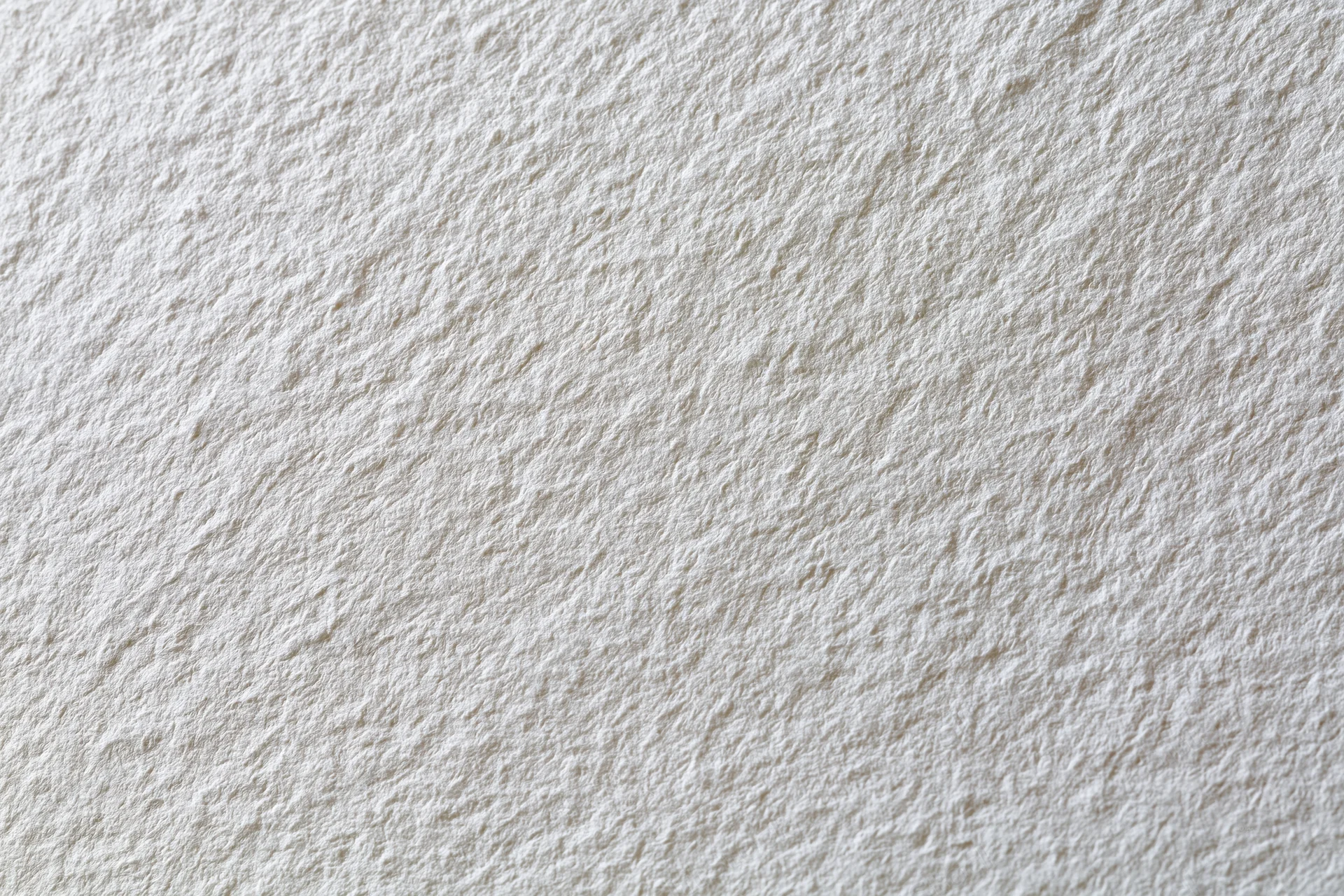 Close-up of blank white watercolor paper surface with textured grain