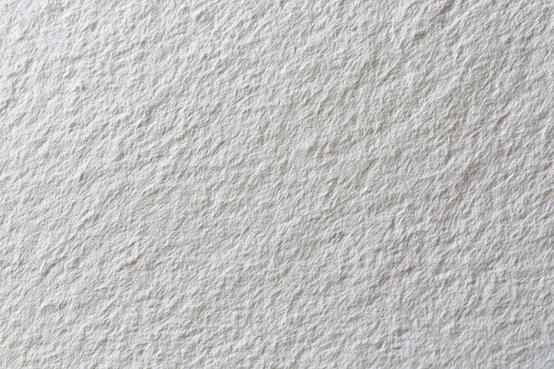 Close-up of blank white watercolor paper surface with textured grain