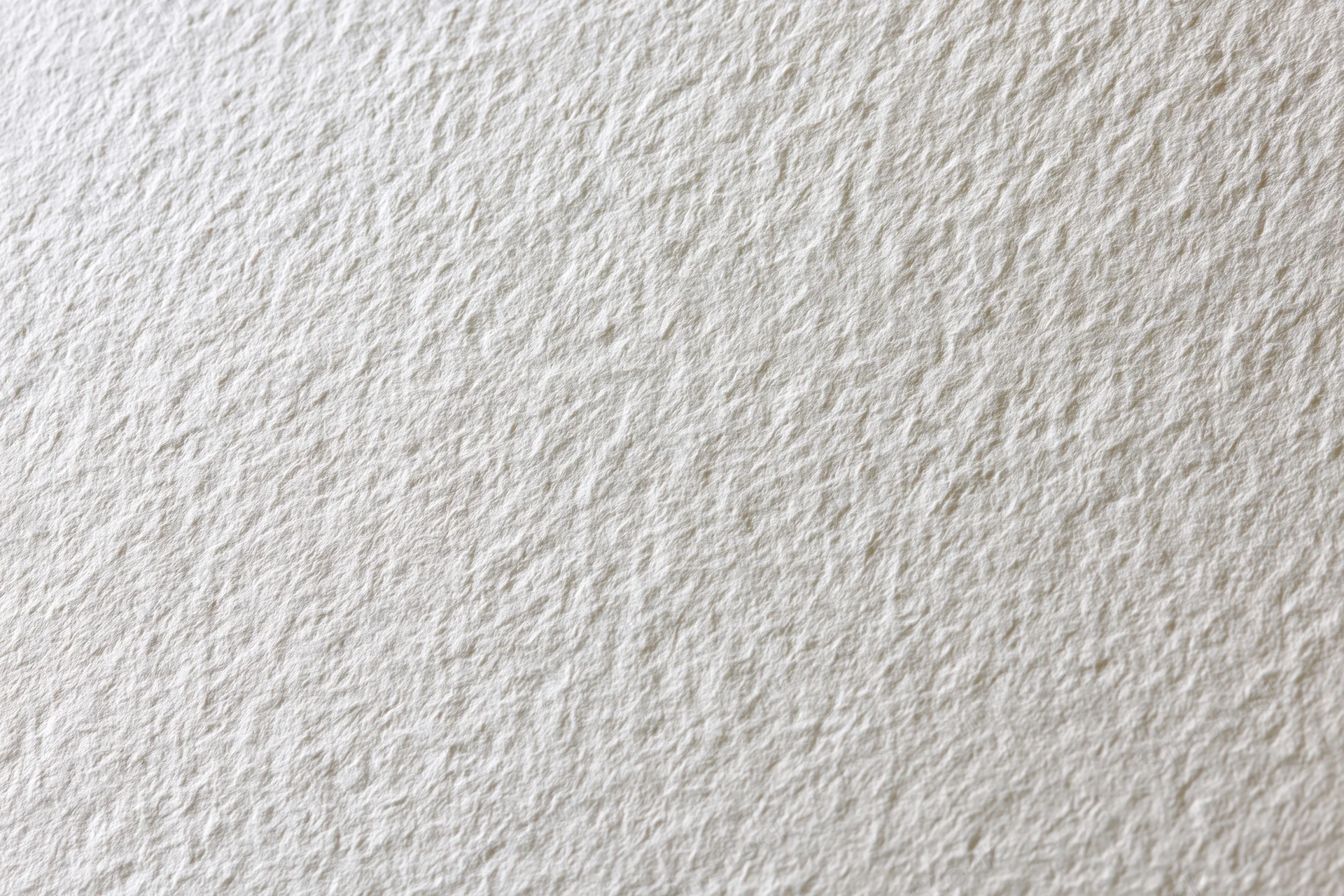 Close-up of blank white watercolor paper with textured surface filling the frame