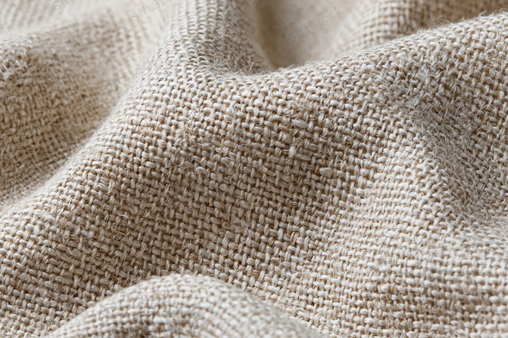 Close-up of natural linen fabric with visible weave and texture filling the frame