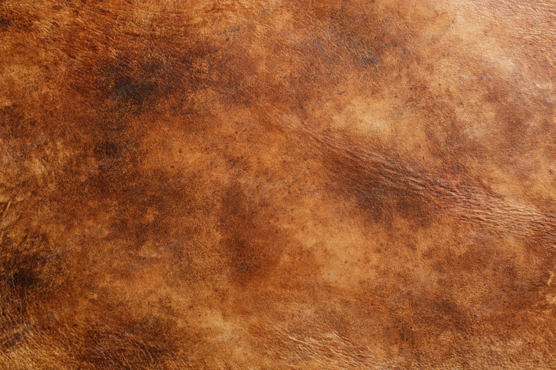 Close-up of aged worn leather surface with natural grain and texture