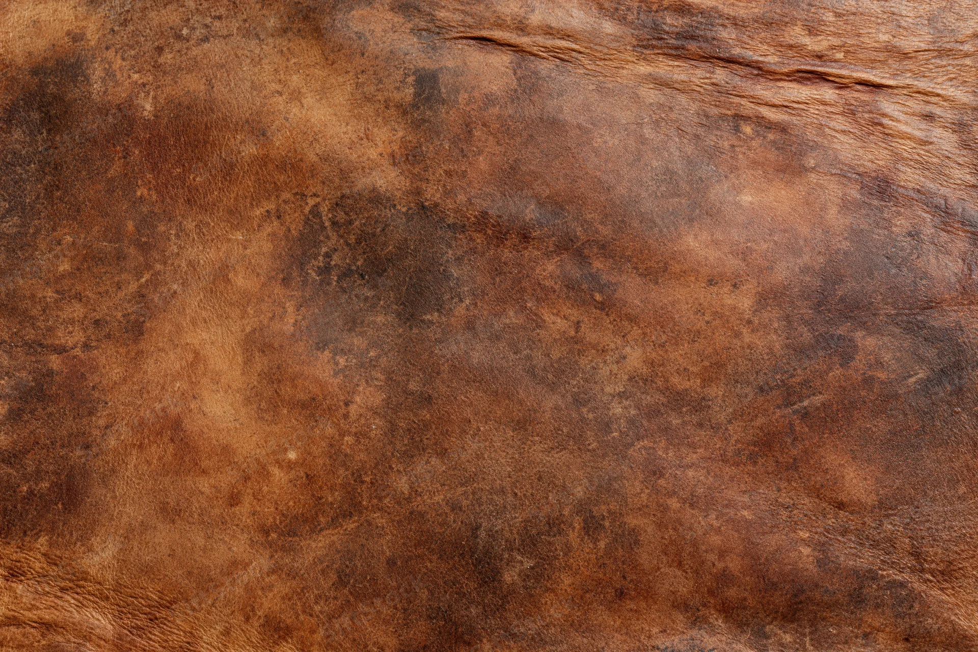 Close-up of aged worn leather surface with natural grain and texture