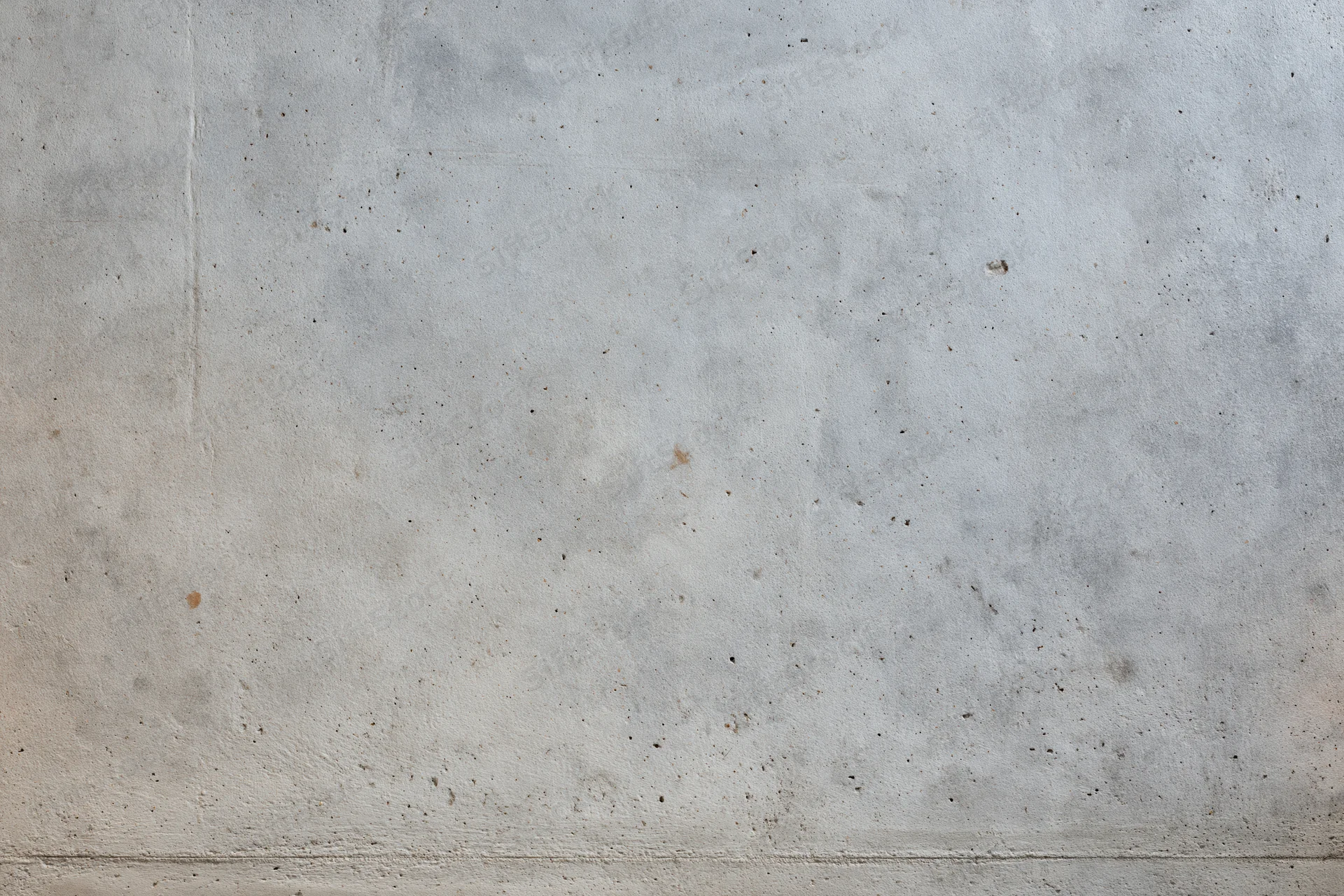 Close-up of a bare concrete wall with rough texture and subtle discoloration