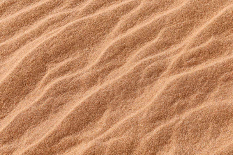 Close-up overhead view of rippled desert sand surface