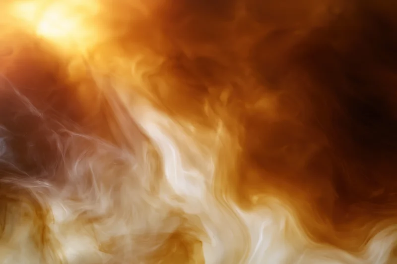 Swirling steam rising from hot coffee as cream dissolves into dark liquid