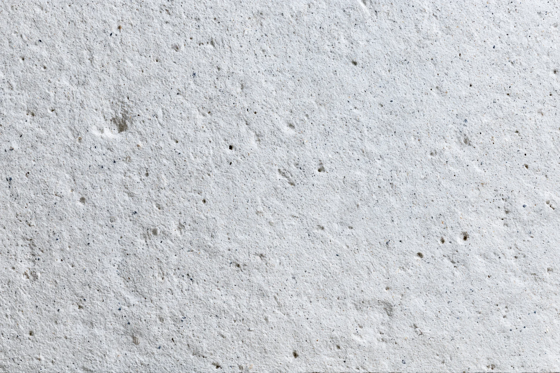 Close-up of a rough gray concrete wall surface filling the frame