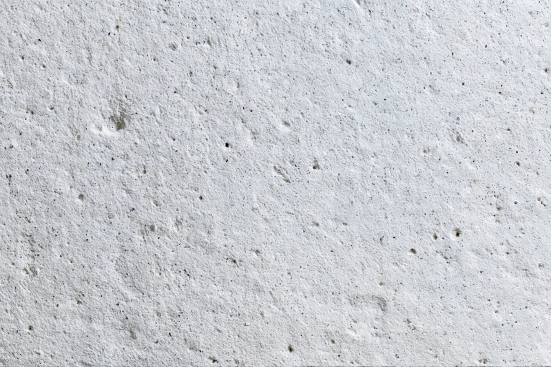 Close-up of a rough gray concrete wall surface filling the frame