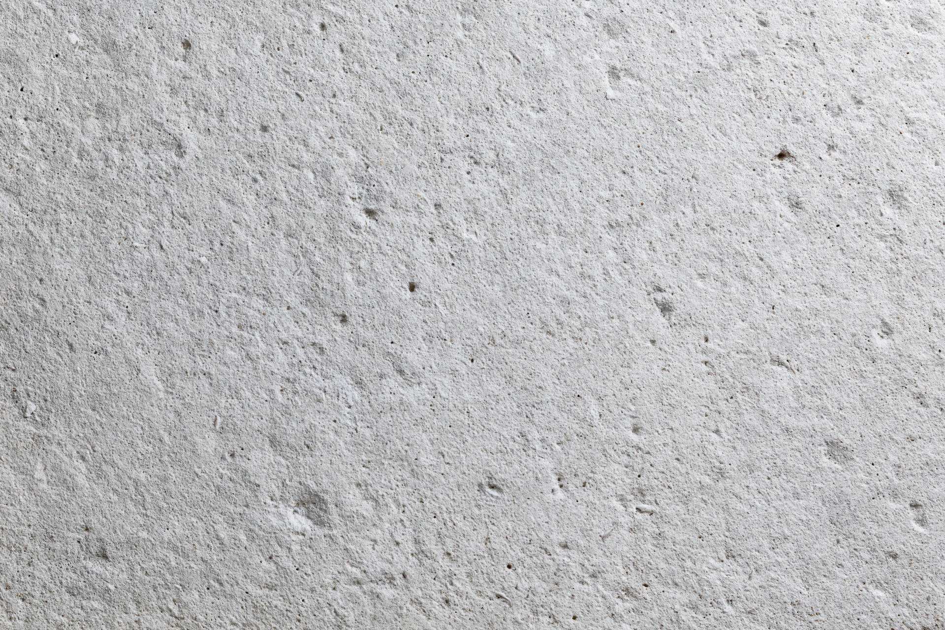 Close-up of a rough gray concrete wall surface filling the frame
