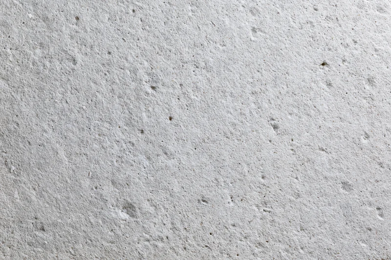 Close-up of a rough gray concrete wall surface filling the frame