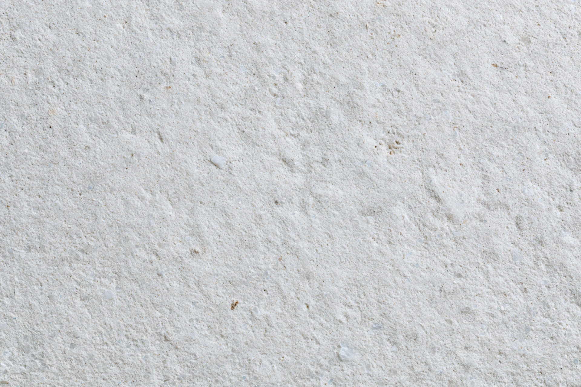 Close-up of a rough concrete surface with natural texture and speckled gray tone