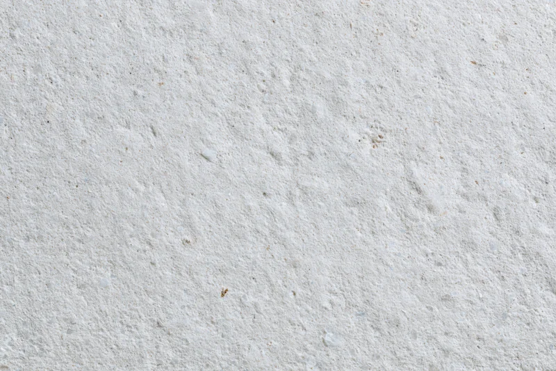Close-up of a rough concrete surface with natural texture and speckled gray tone