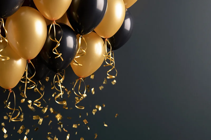 Gold and black helium balloons clustered in the upper left with falling gold confetti against a dark background, copyspace on the right