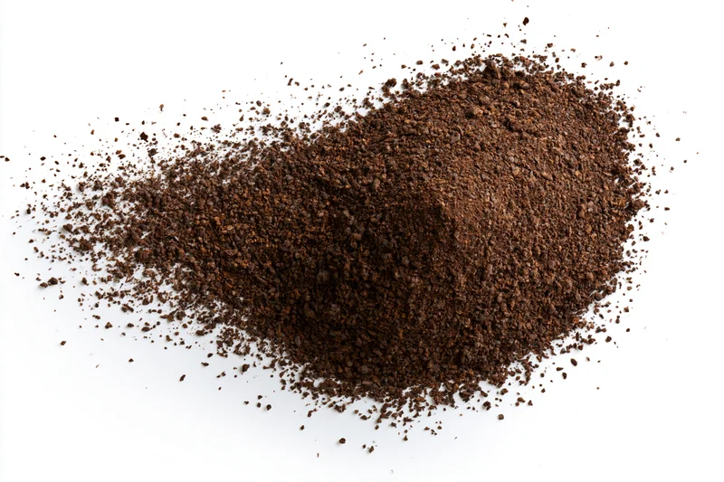 Ground coffee powder scattered and exploding outward on white background