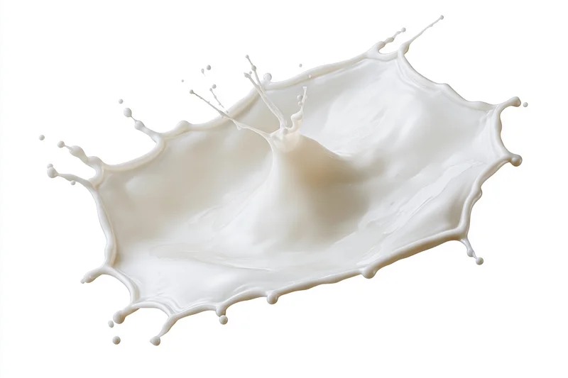 Milk splash frozen in motion forming an irregular crown shape against white background
