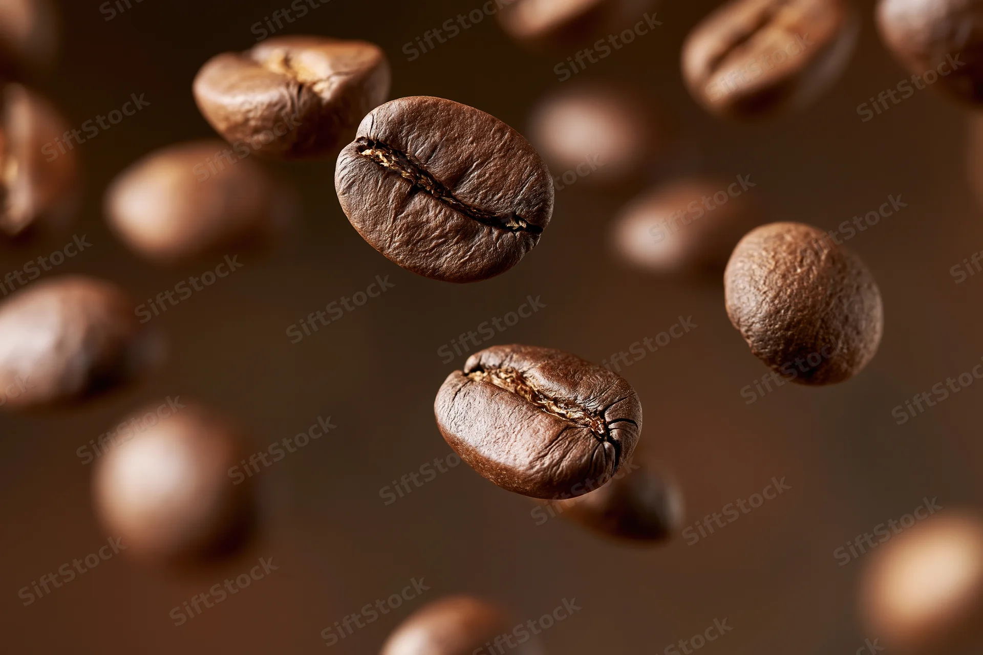 Roasted coffee beans floating midair in closeup view