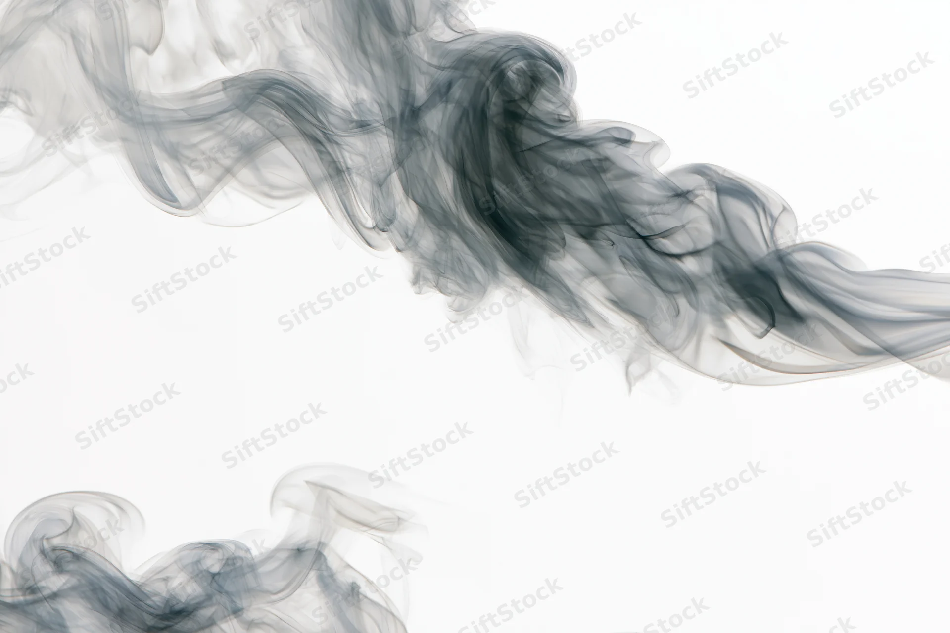 Dark smoke wisps curling and drifting upward against a white background