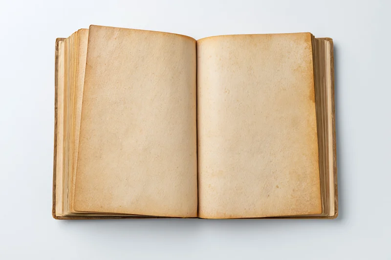 Open vintage hardcover book with blank aged pages on white background