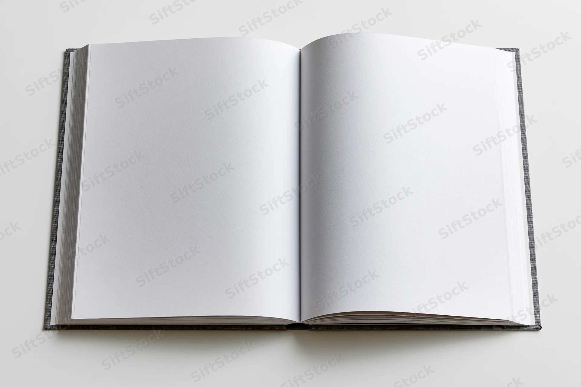 Open hardcover book with blank white pages lying flat on a white surface
