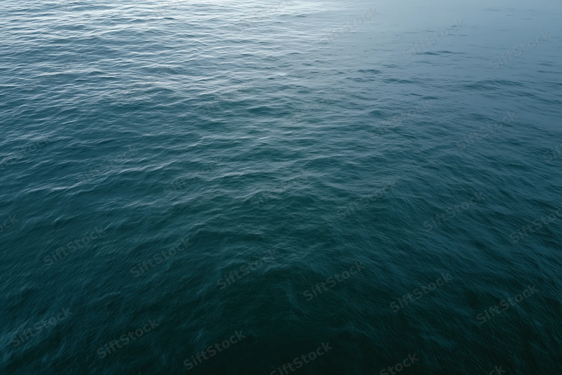 Aerial view of open ocean surface with gentle ripples and no horizon