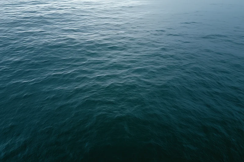 Aerial view of open ocean surface with gentle ripples and no horizon