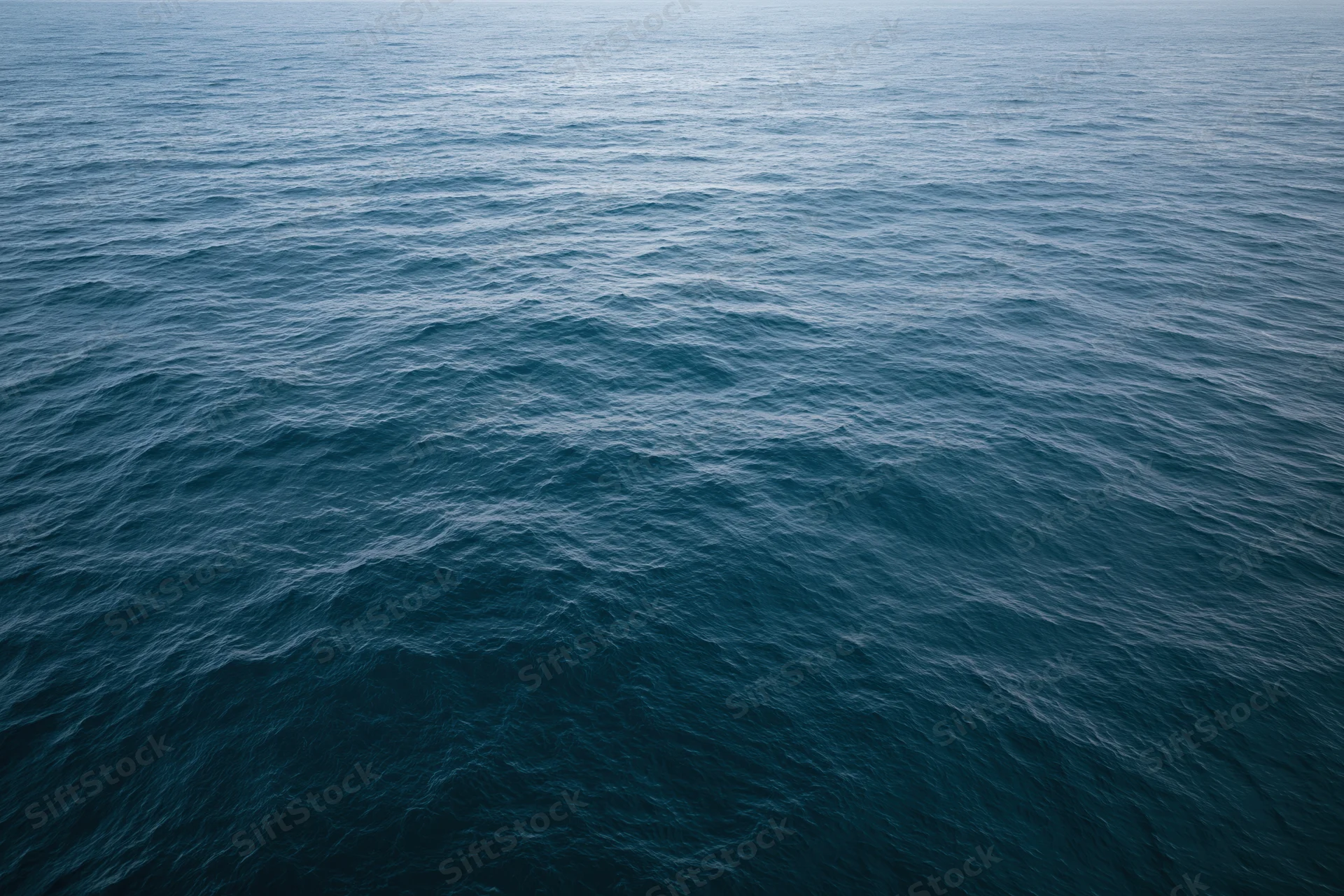 Aerial view of open ocean surface with gentle waves and no horizon