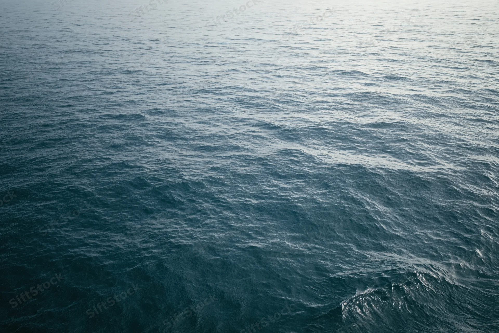 Aerial view of open ocean surface with gentle waves and no horizon visible