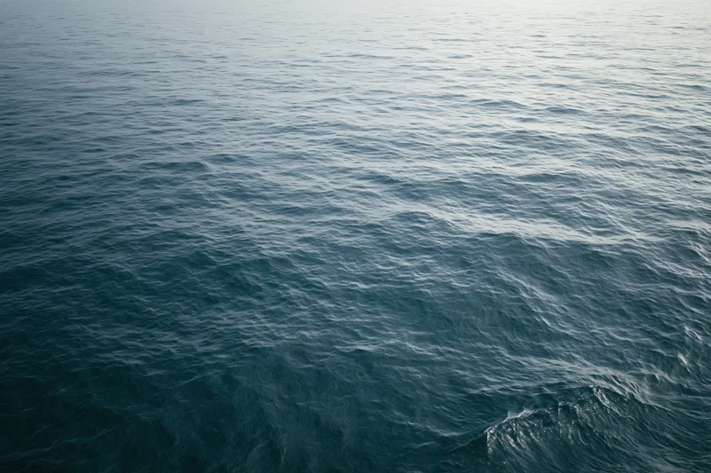 Aerial view of open ocean surface with gentle waves and no horizon visible