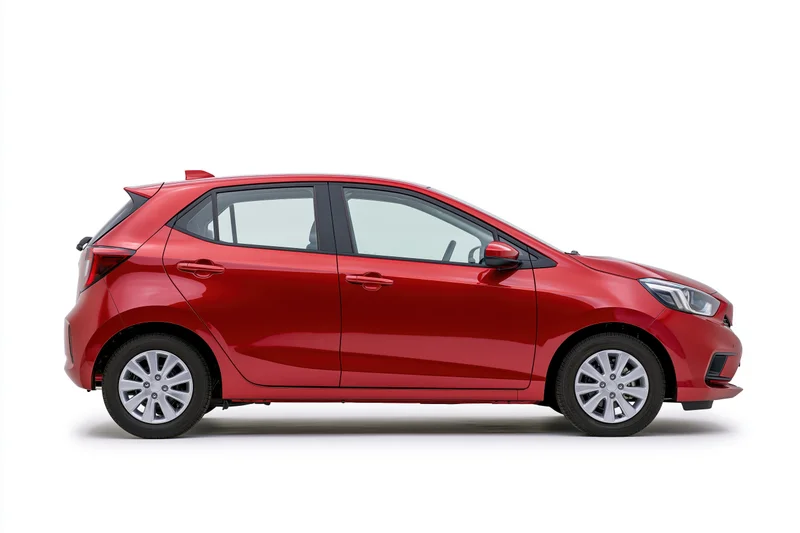 Red compact hatchback car in clean side profile view isolated on white background