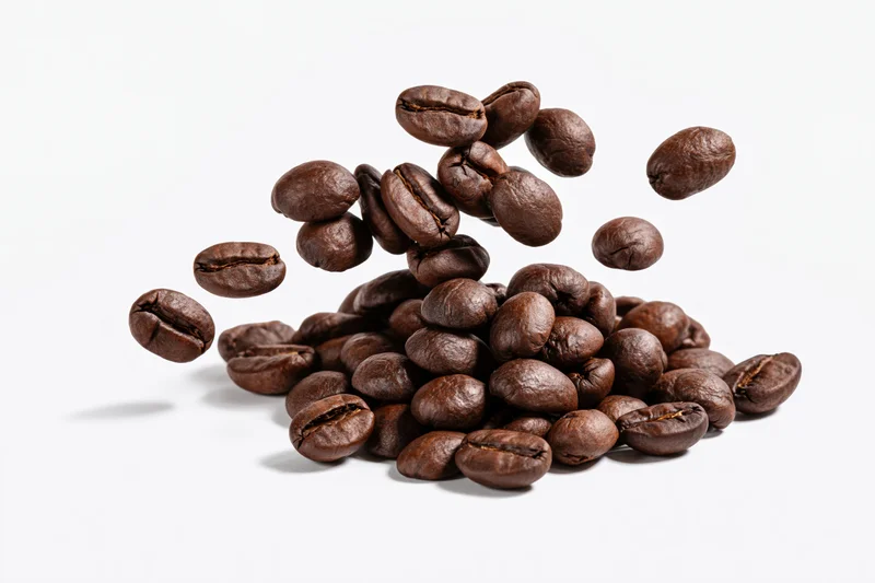Roasted coffee beans falling onto a small pile is shown