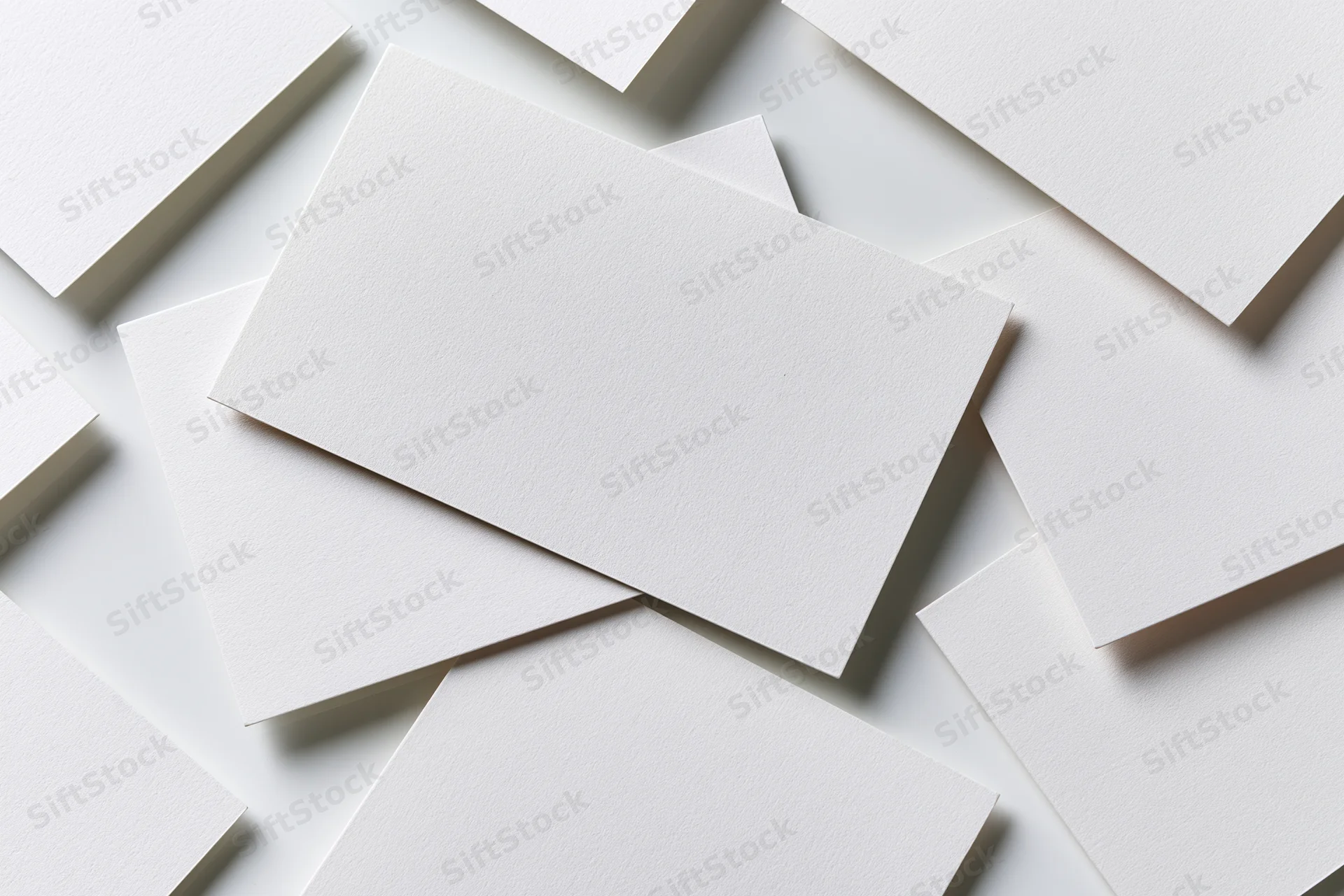 Blank white rectangular cards arranged diagonally on a white surface