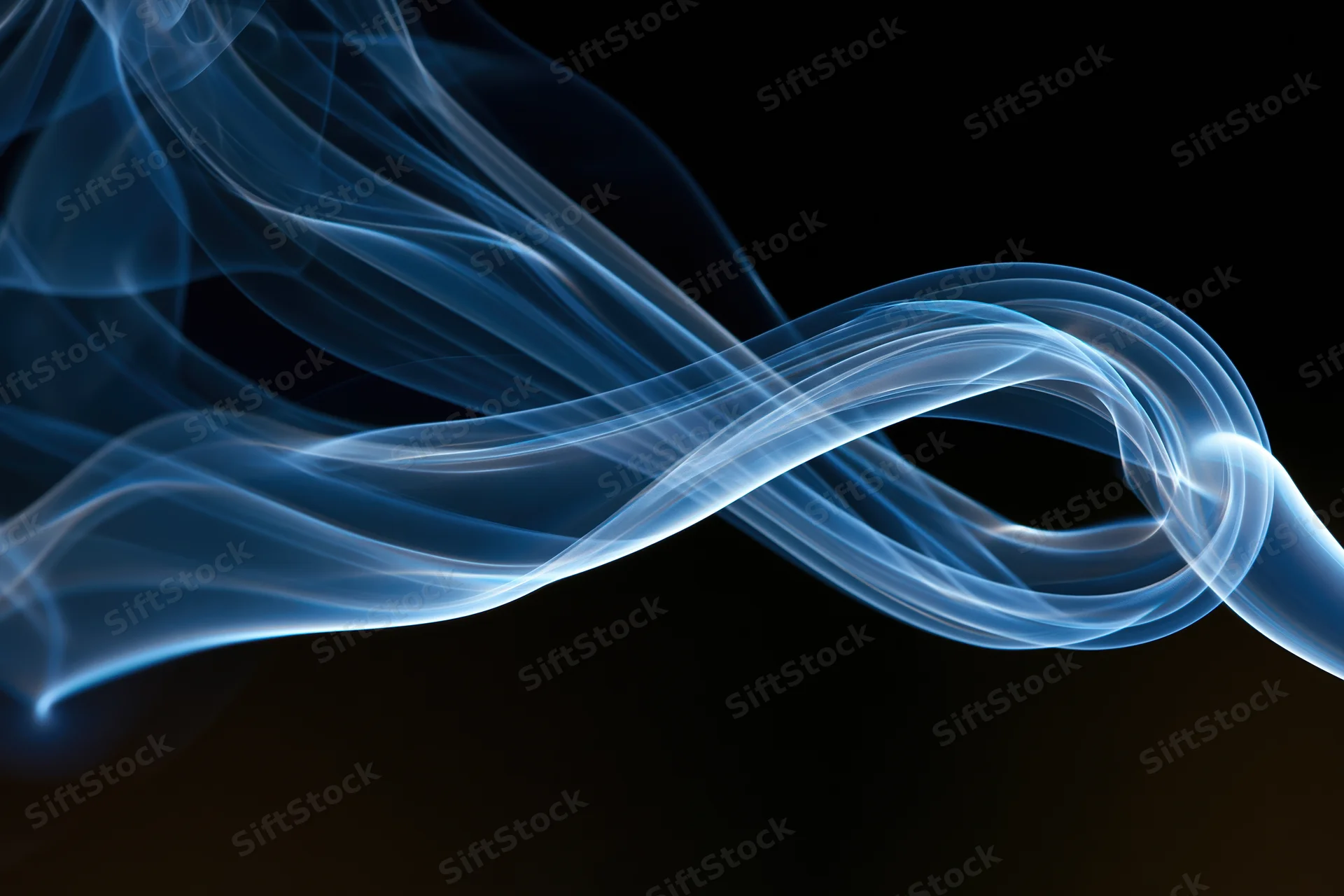 Thin blue incense smoke curling into a looping swirl against a dark background