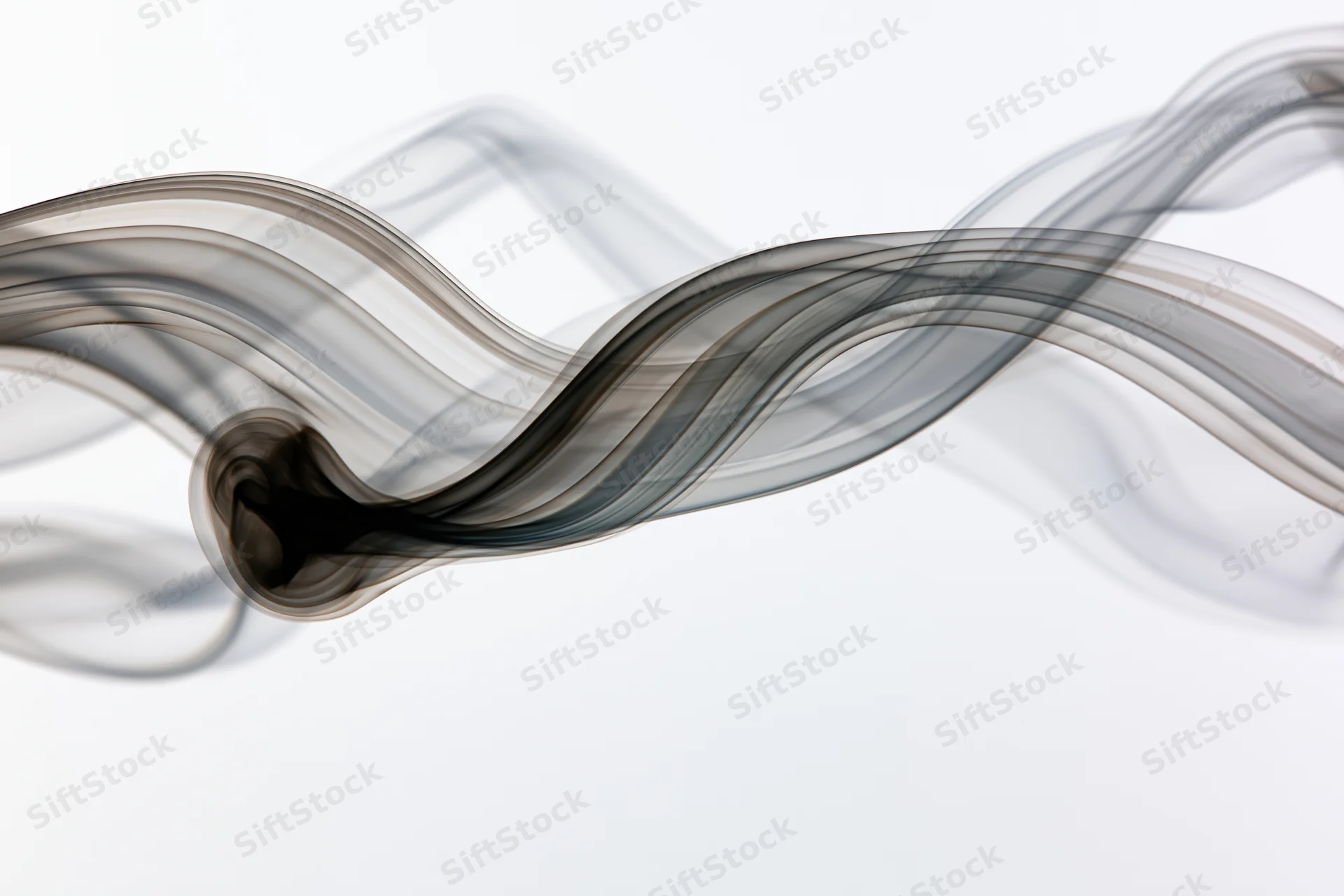 Dark smoke wisps curling and flowing in slow motion against a white background