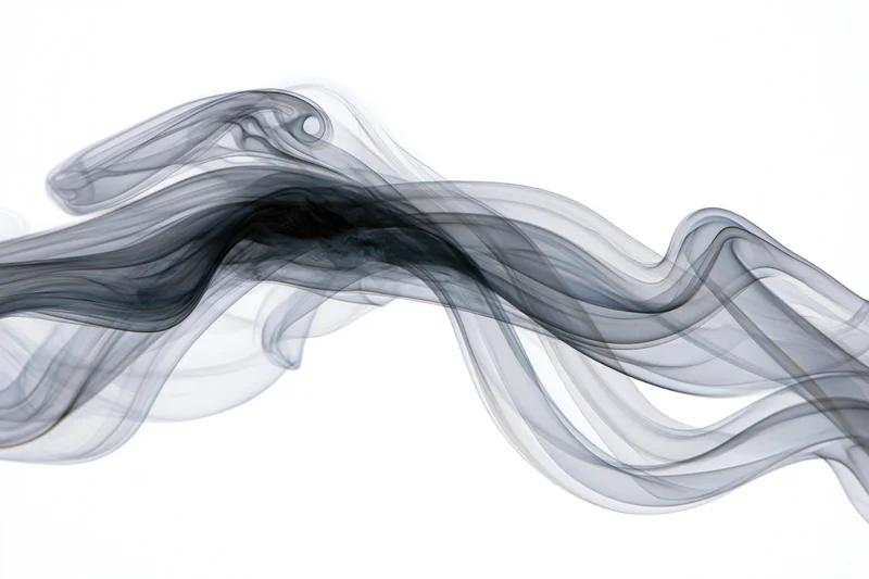 Dark wisps of smoke curling and flowing in slow motion against a white background