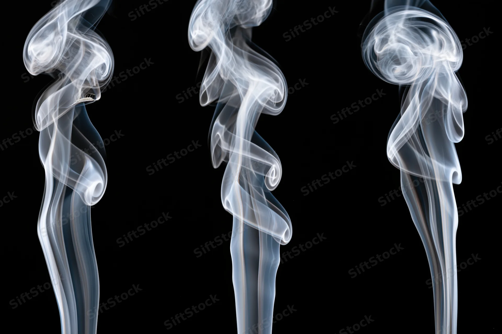 Three white smoke wisps rising and curling upward against a black background