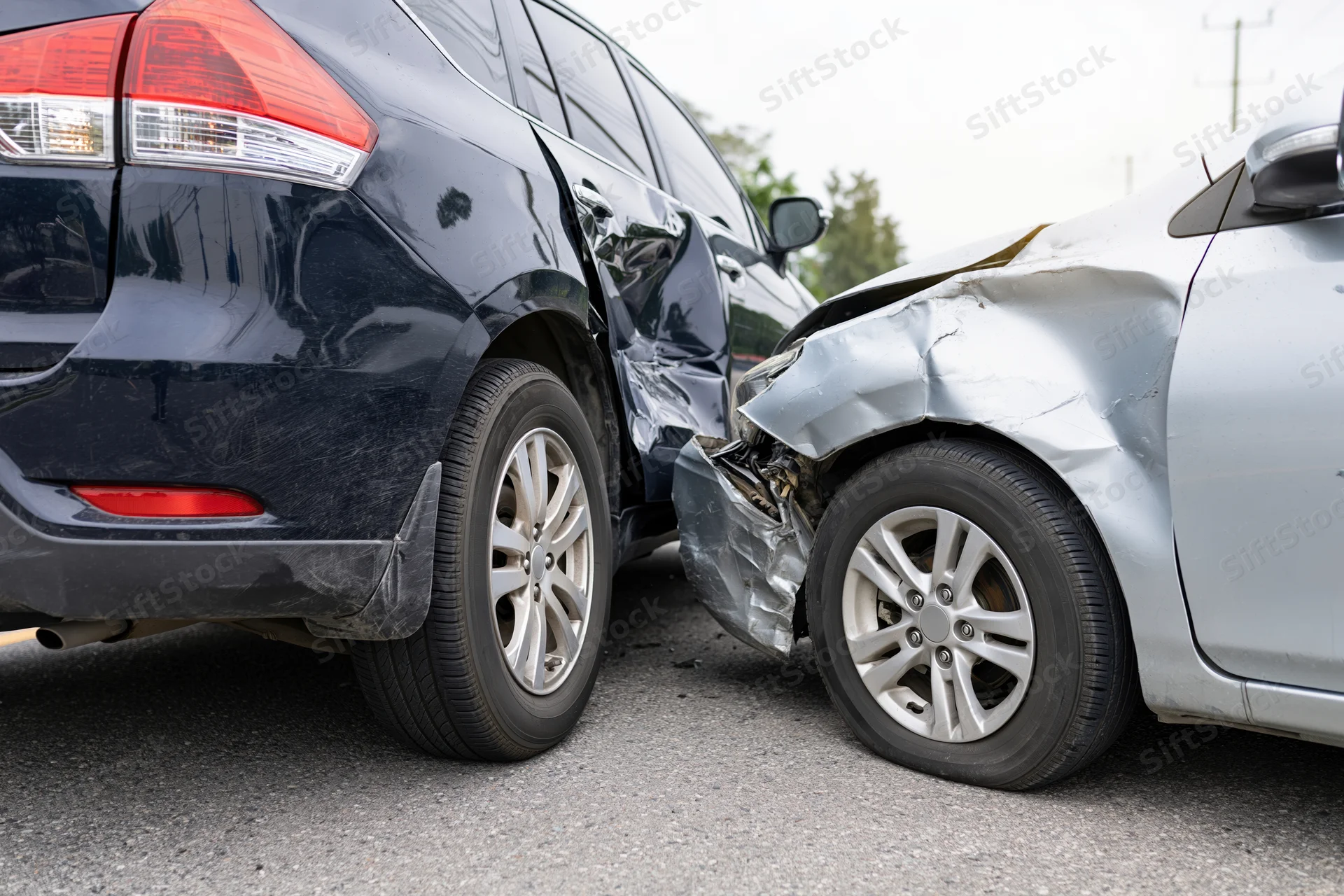 Two damaged cars after rear-end collision on road