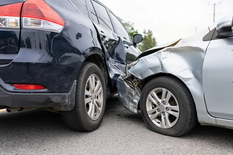 Two damaged cars after rear-end collision on road
