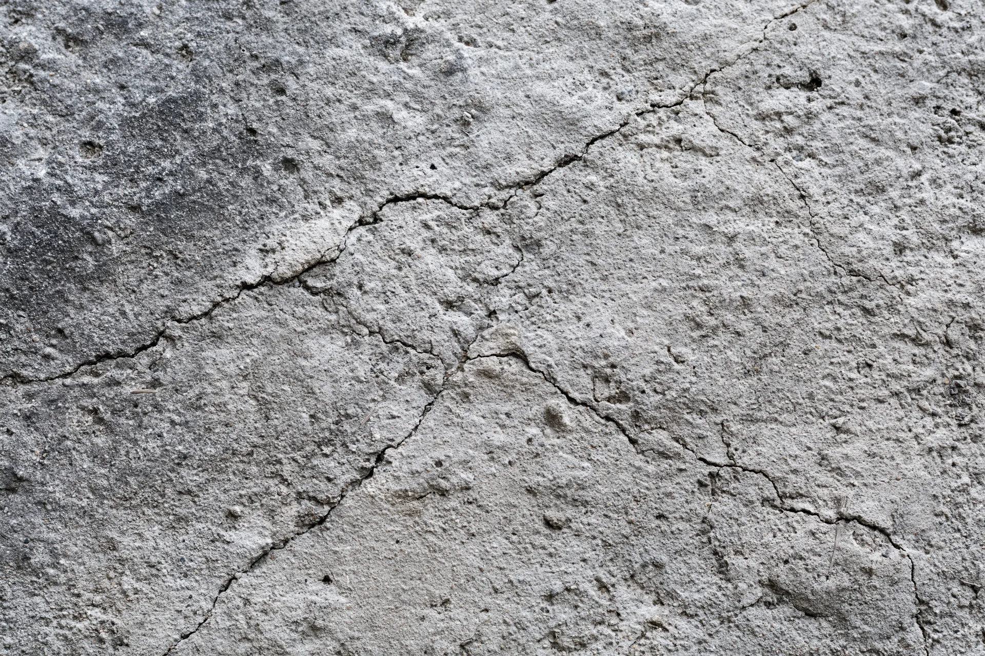 Cracked weathered concrete surface showing signs of wear and age
