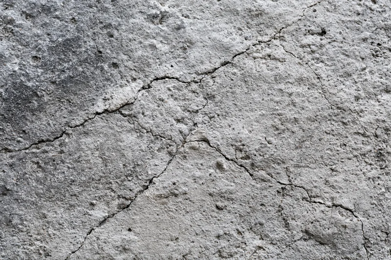 Cracked weathered concrete surface showing signs of wear and age
