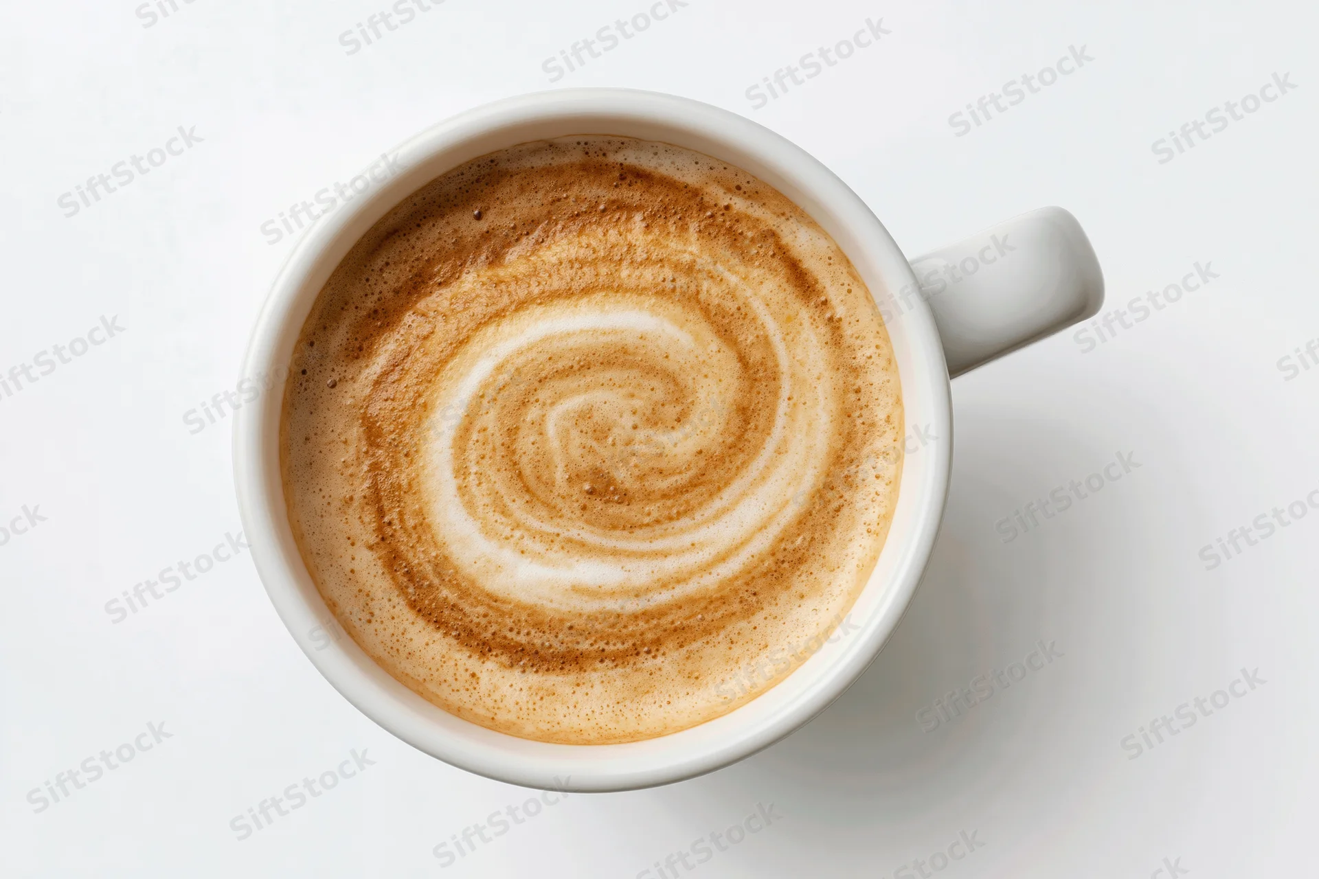 Overhead view of a white ceramic coffee cup filled with latte foam swirl on a plain white surface