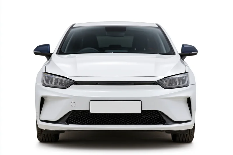White modern electric sedan viewed straight-on from front against plain white background