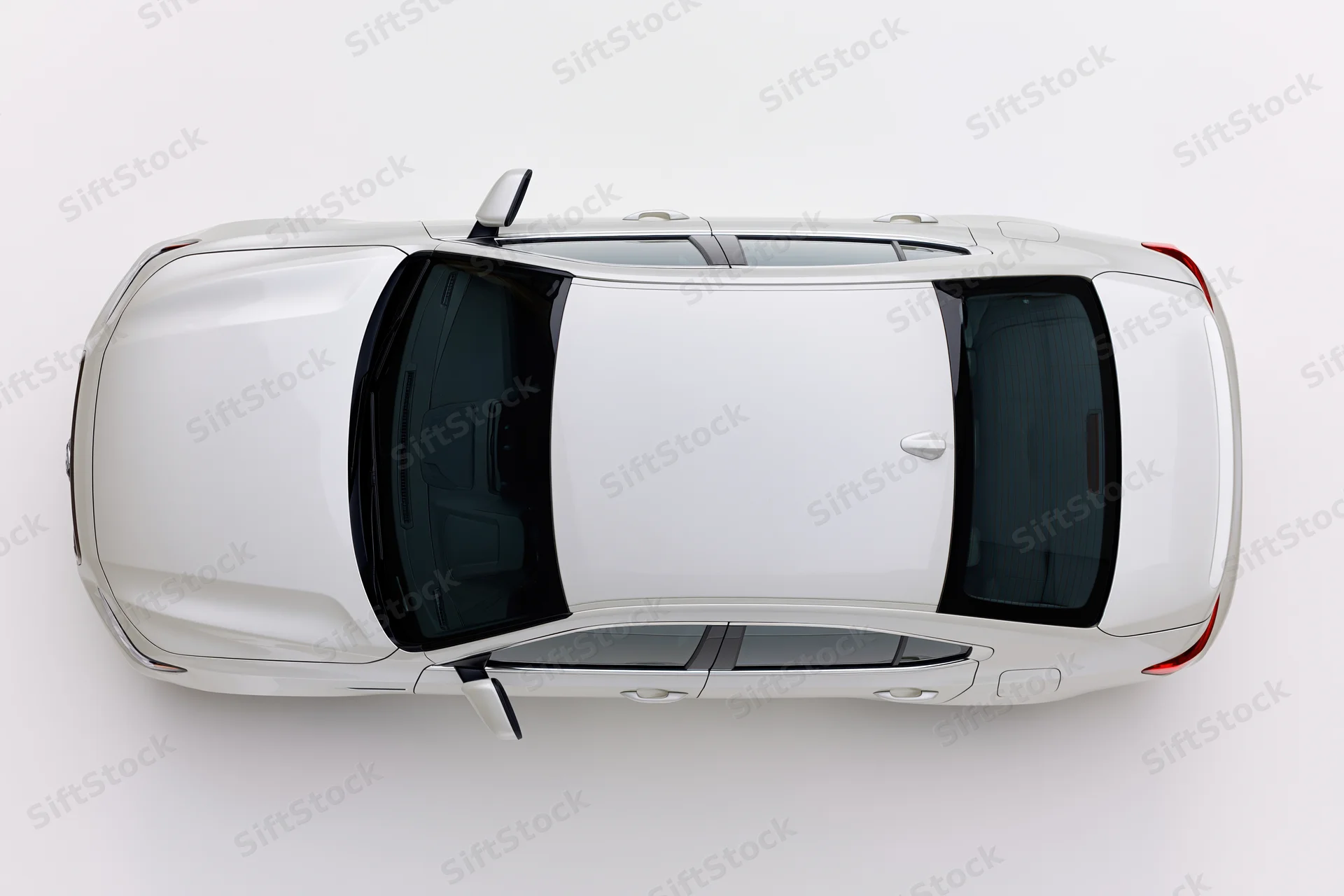 White sedan viewed from directly above against a plain white background