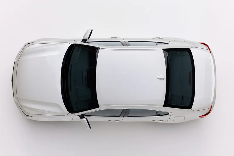 White sedan viewed from directly above against a plain white background