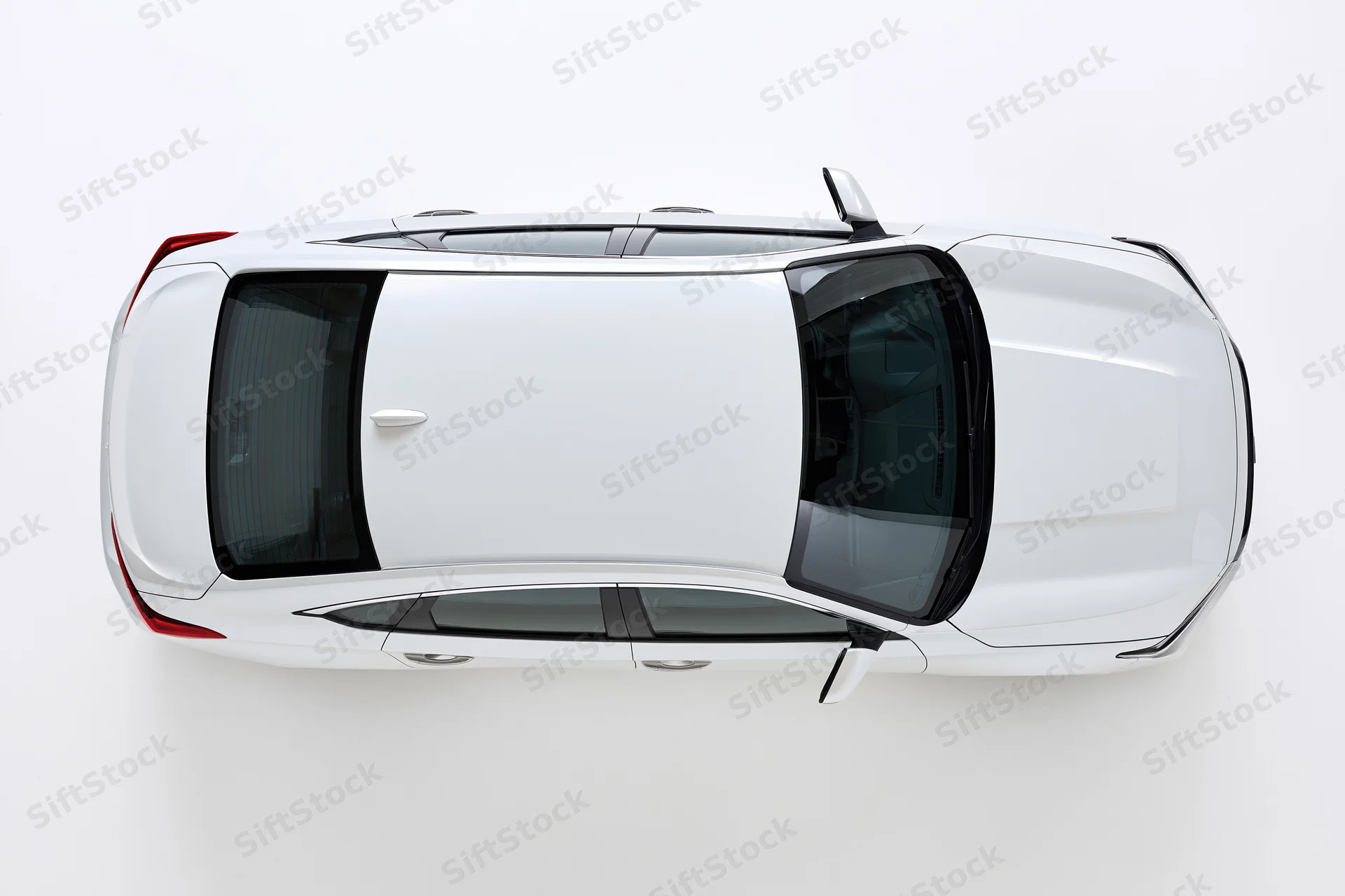 White sedan viewed from directly overhead against a plain white background