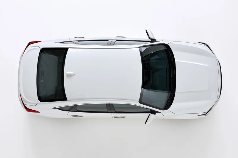 White sedan viewed from directly overhead against a plain white background