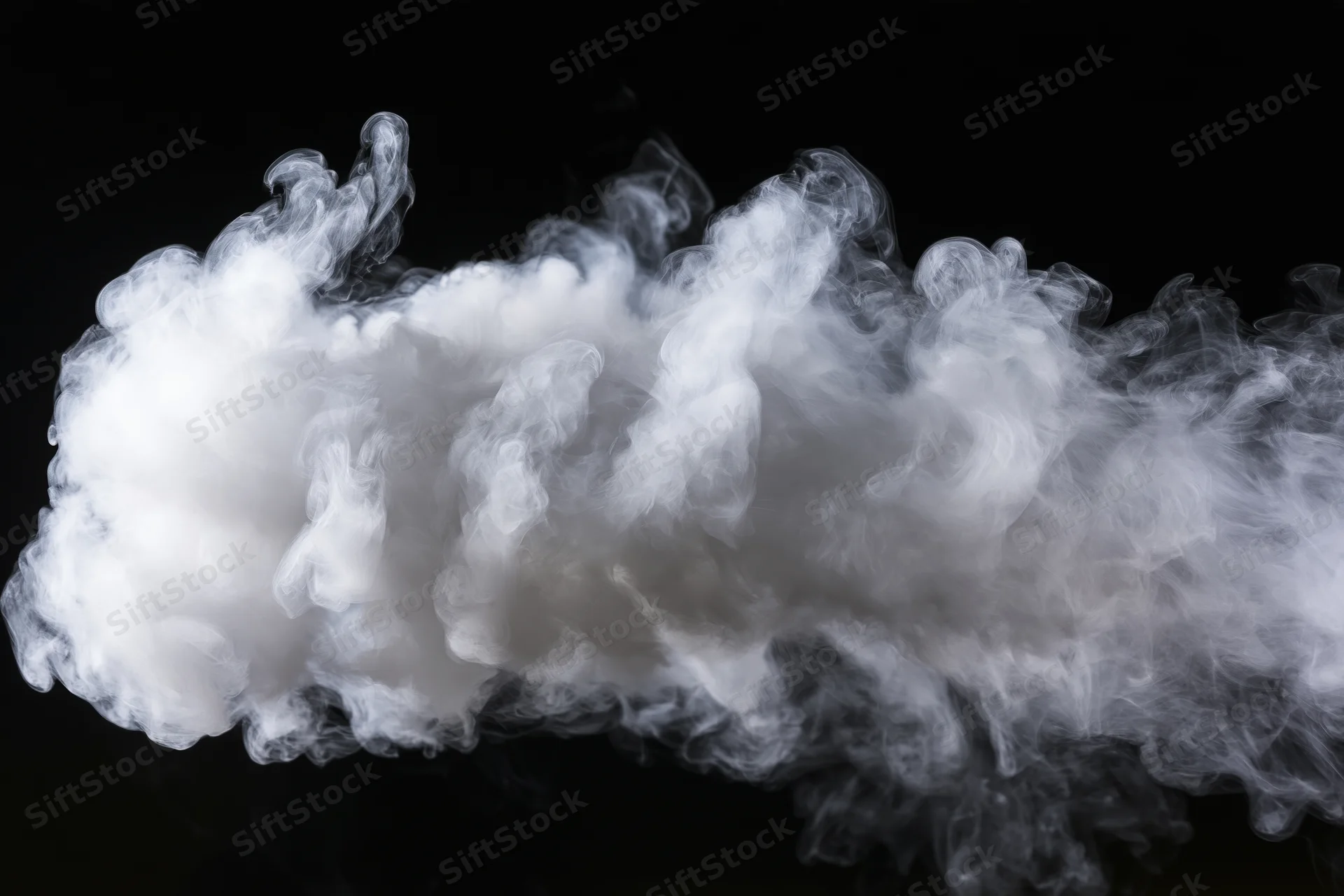 White smoke cloud drifting and dispersing mid-air against black background