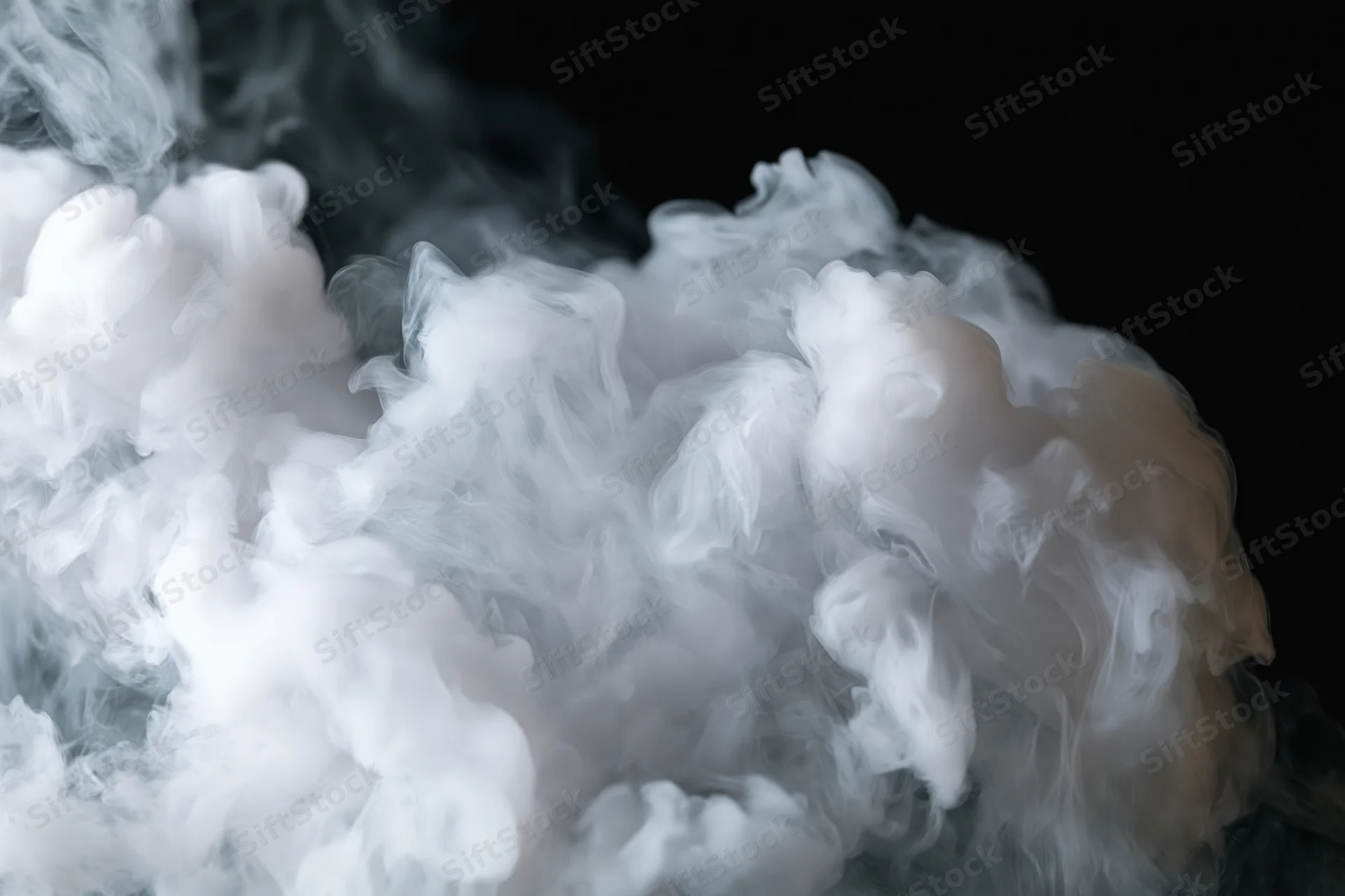 White smoke billowing and curling upward against a black background