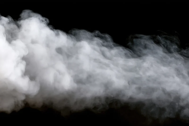 White smoke drifting horizontally across black background