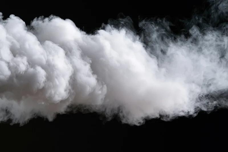 White smoke drifting horizontally across black background