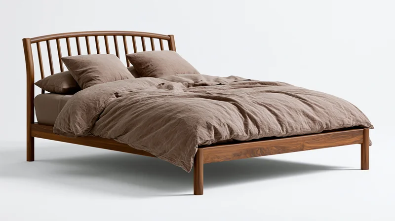 Wooden bed with brown linen bedding and slatted headboard on white background